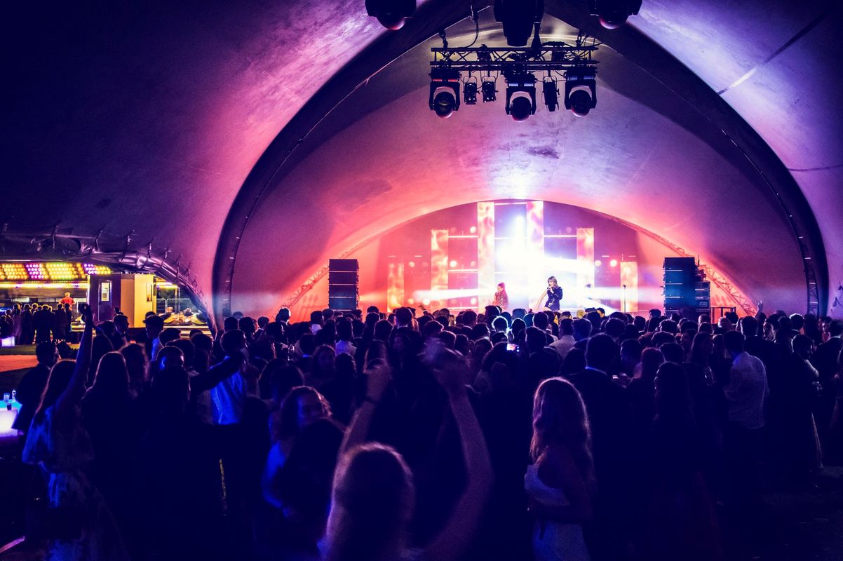 The crowd watch the performers on stage.