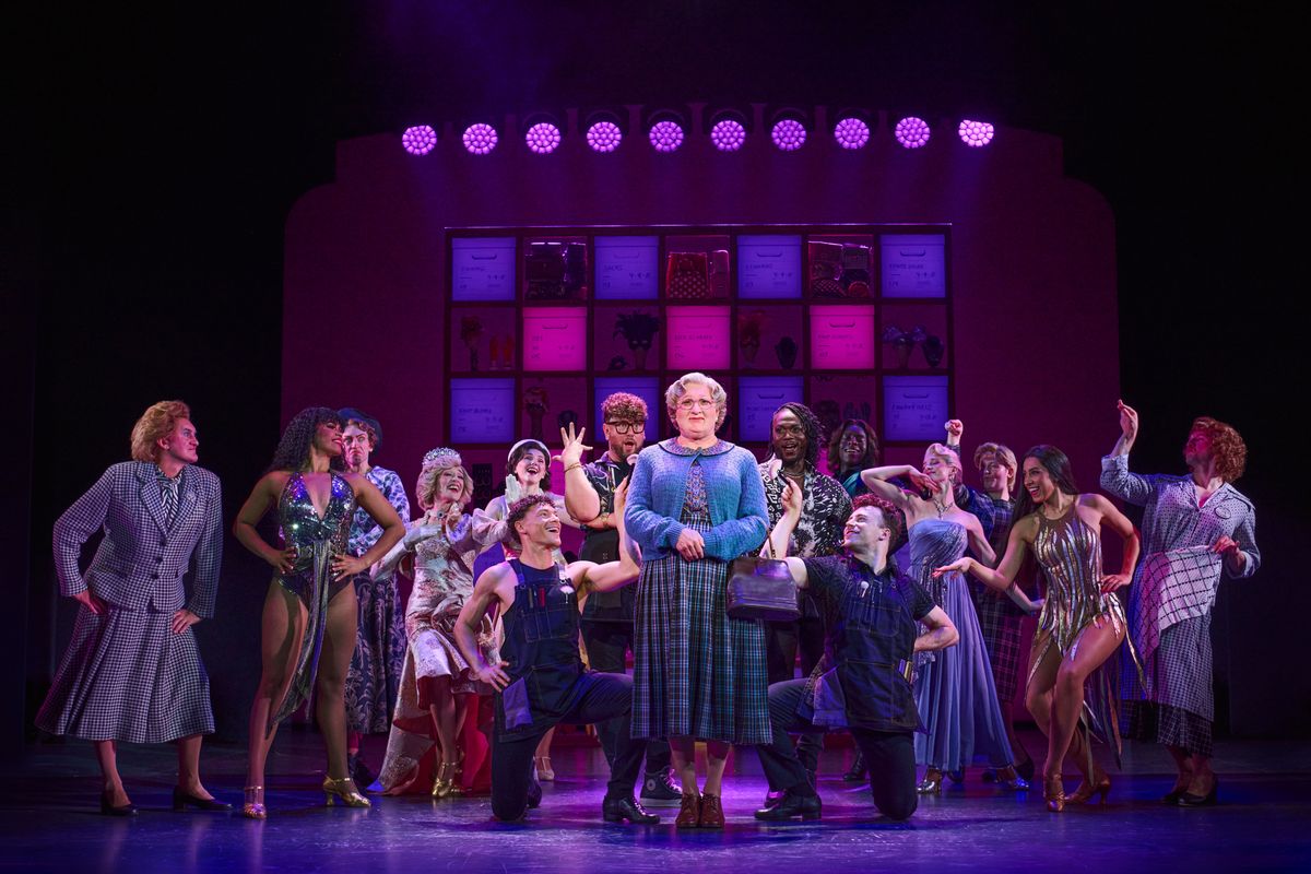 Mrs Doubtfire stands centre stage surrounded by an array of characters.