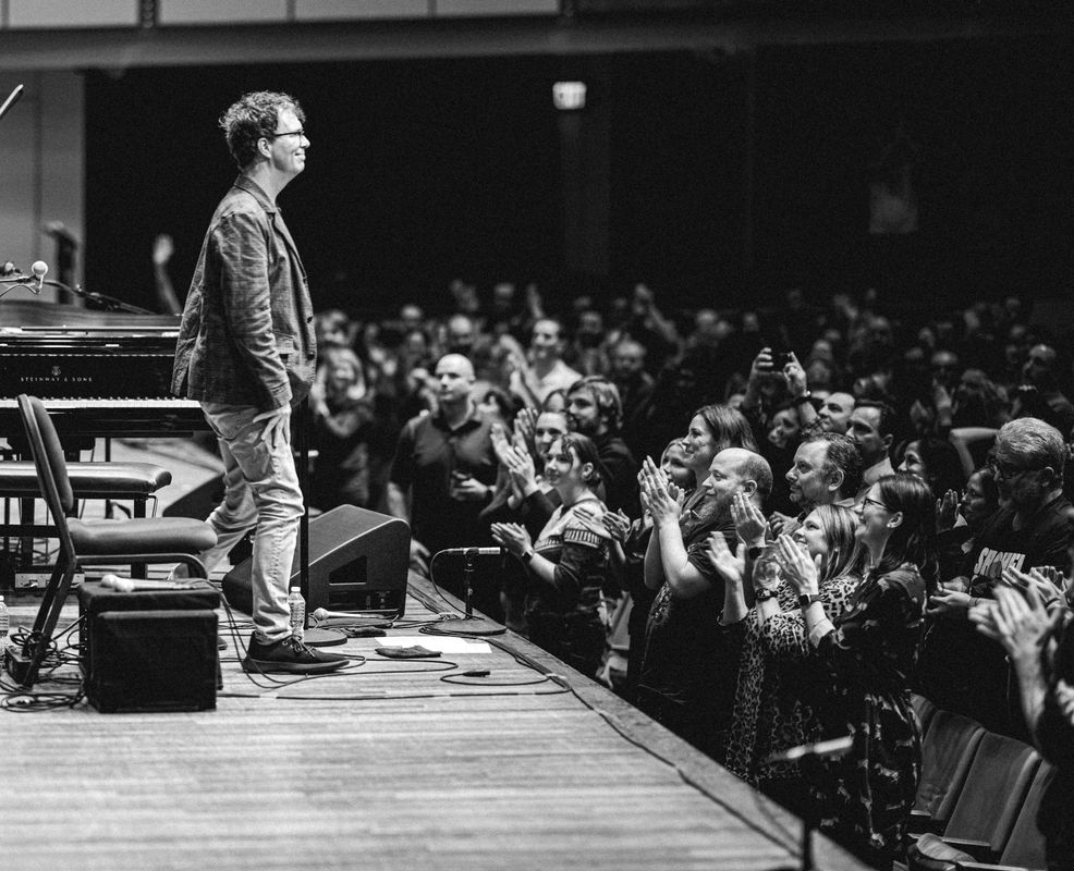 Ben Folds stood on  stage
