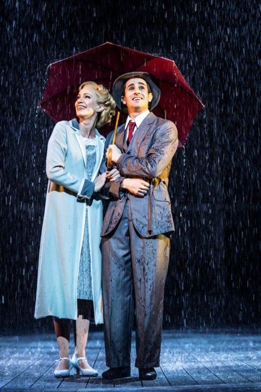 A man and a woman under an umbrella as it rains