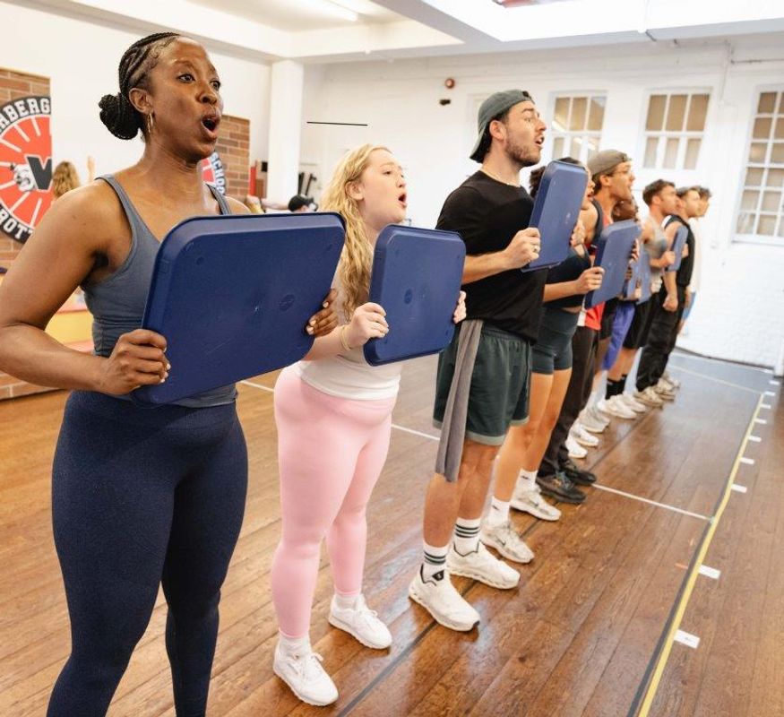 People in active wear rehearsing in rehearsal studio