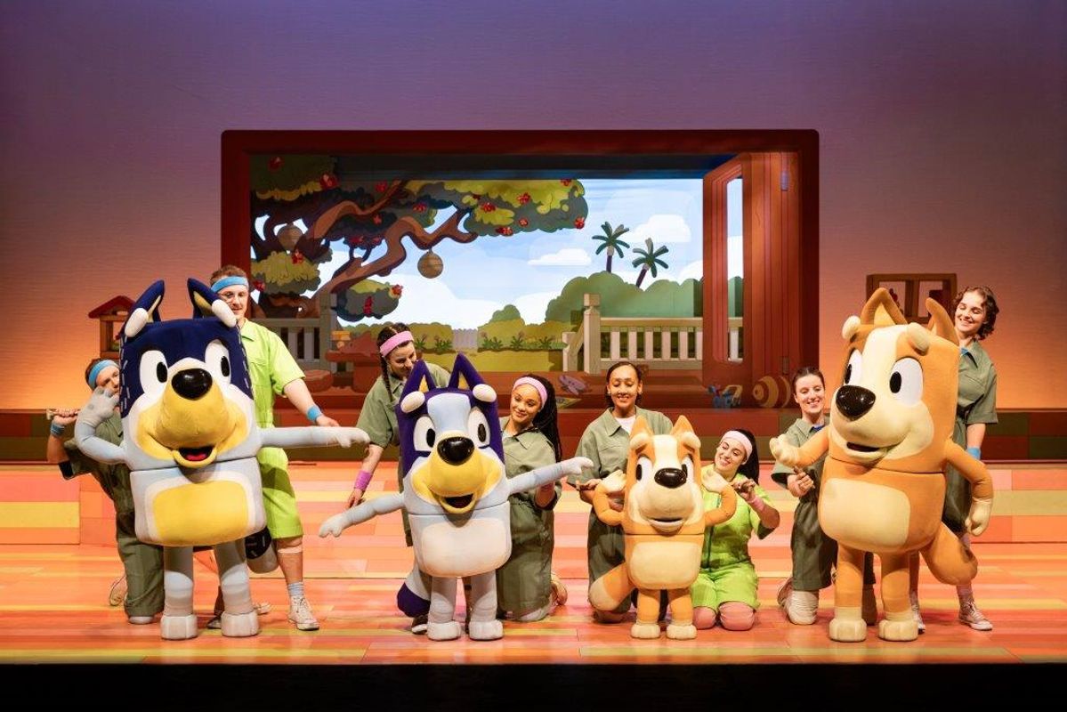 Bluey, Bingo, Mum and Dad dance on stage.