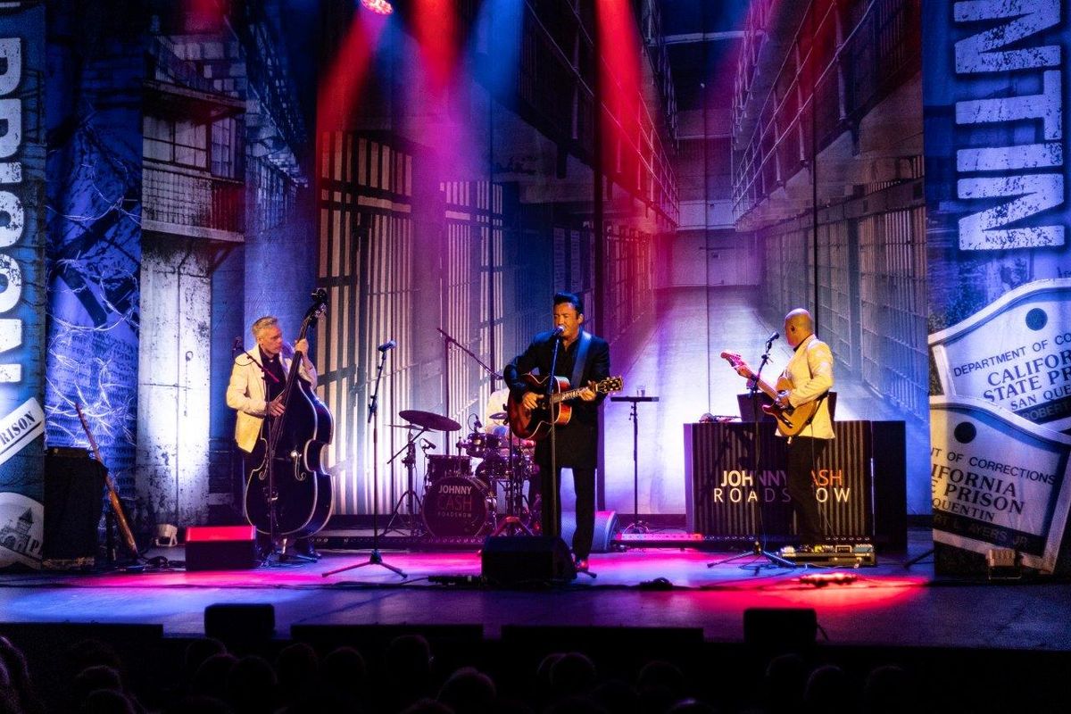 Johnny Cash Roadshow and band performing on stage.