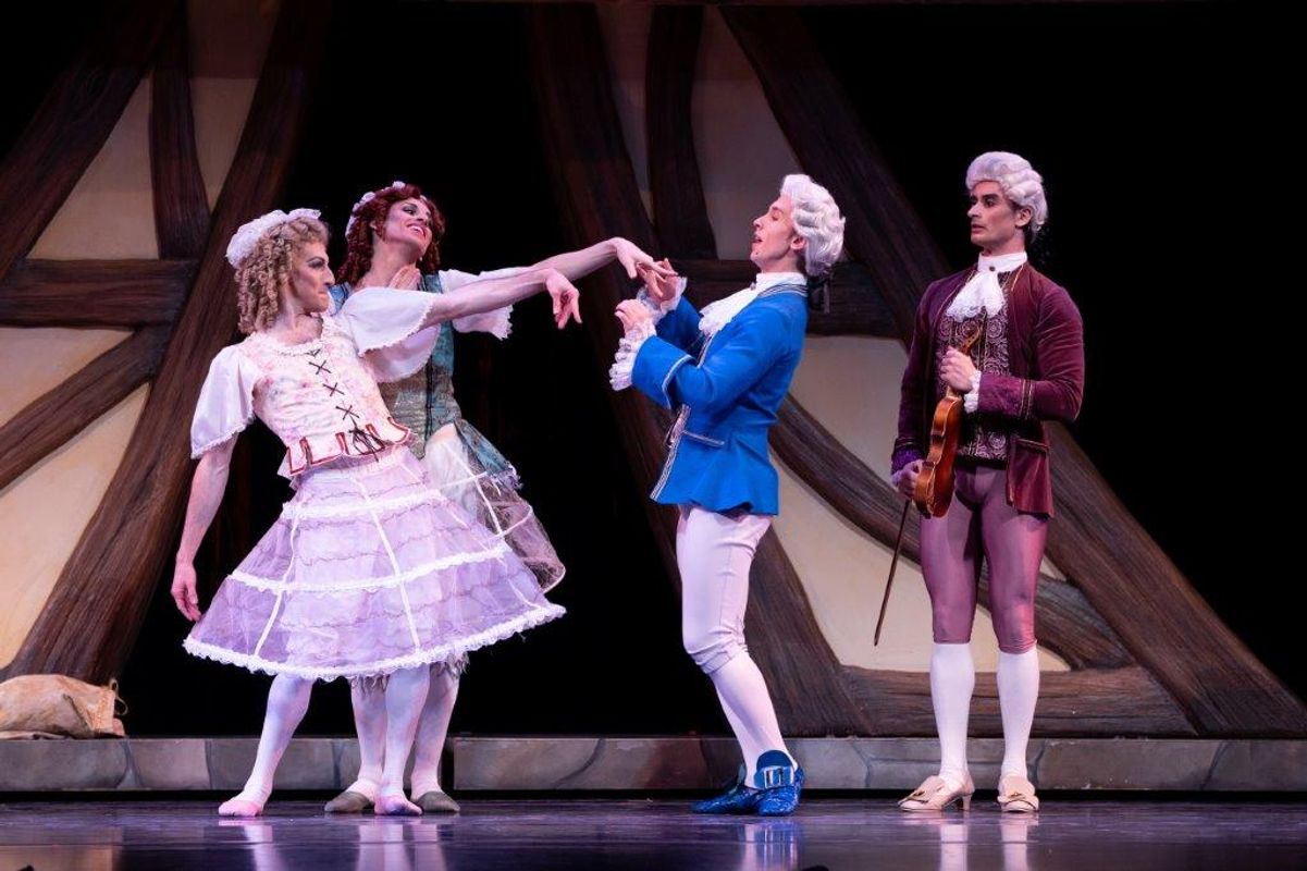 The Milwaukee Company dancing on stage for the production of Northern Ballet Cinderella. The are wearing Victorian styles costumes and are moving elegantly.