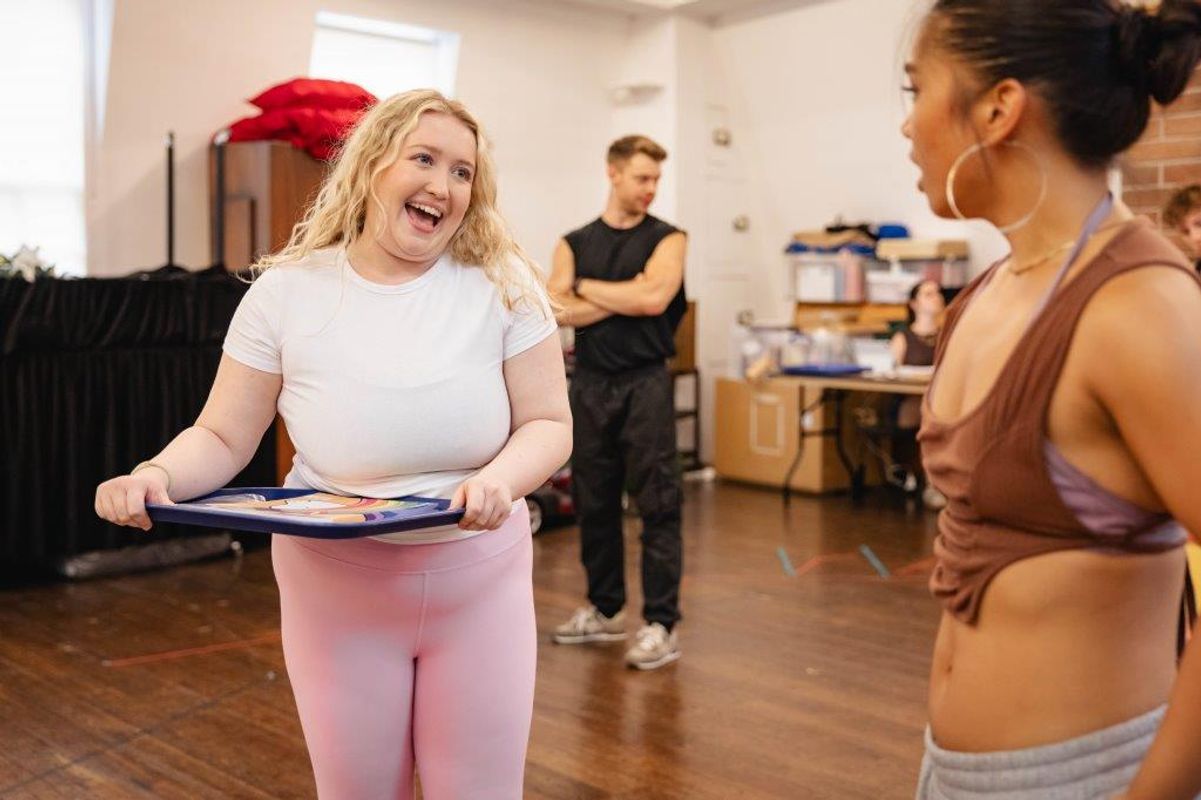People in active wear rehearsing in rehearsal studio