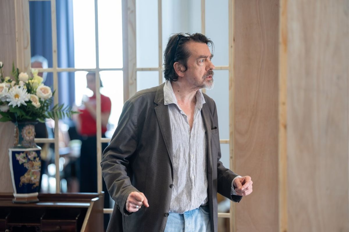 A man looking on clenching his fists