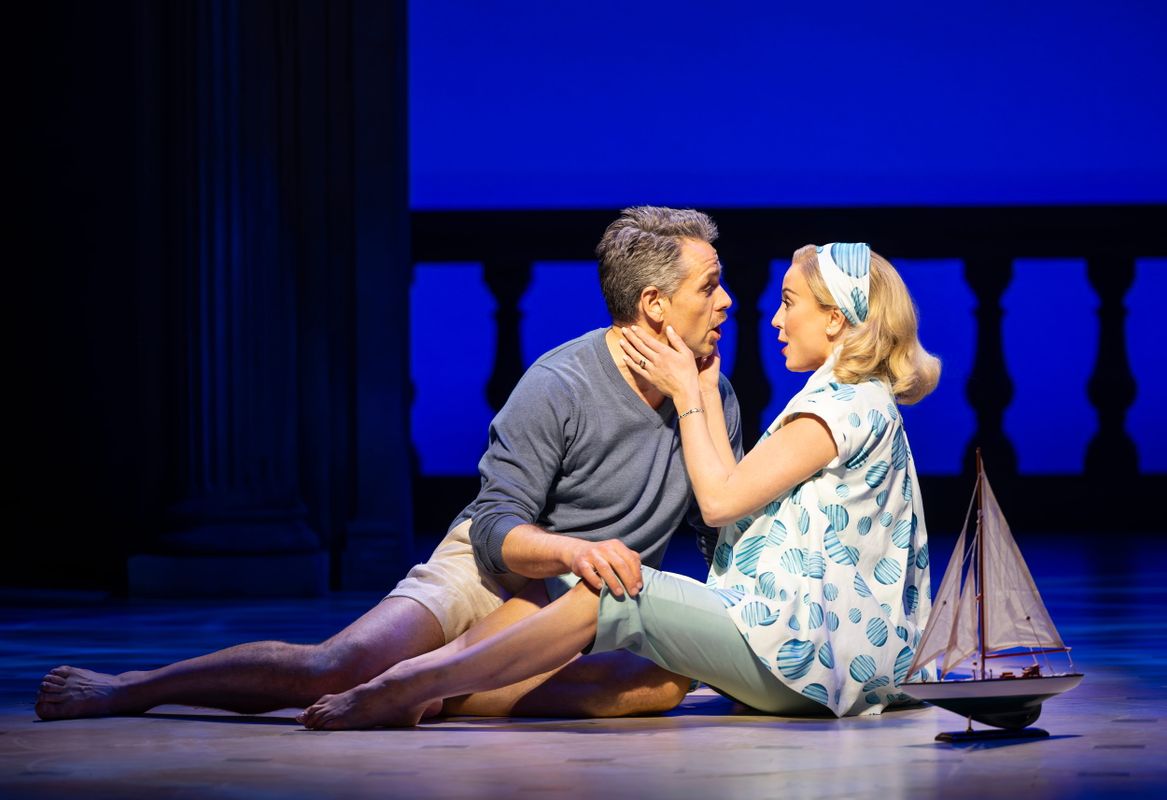 Two cast members of High Society in a romantic embrace.