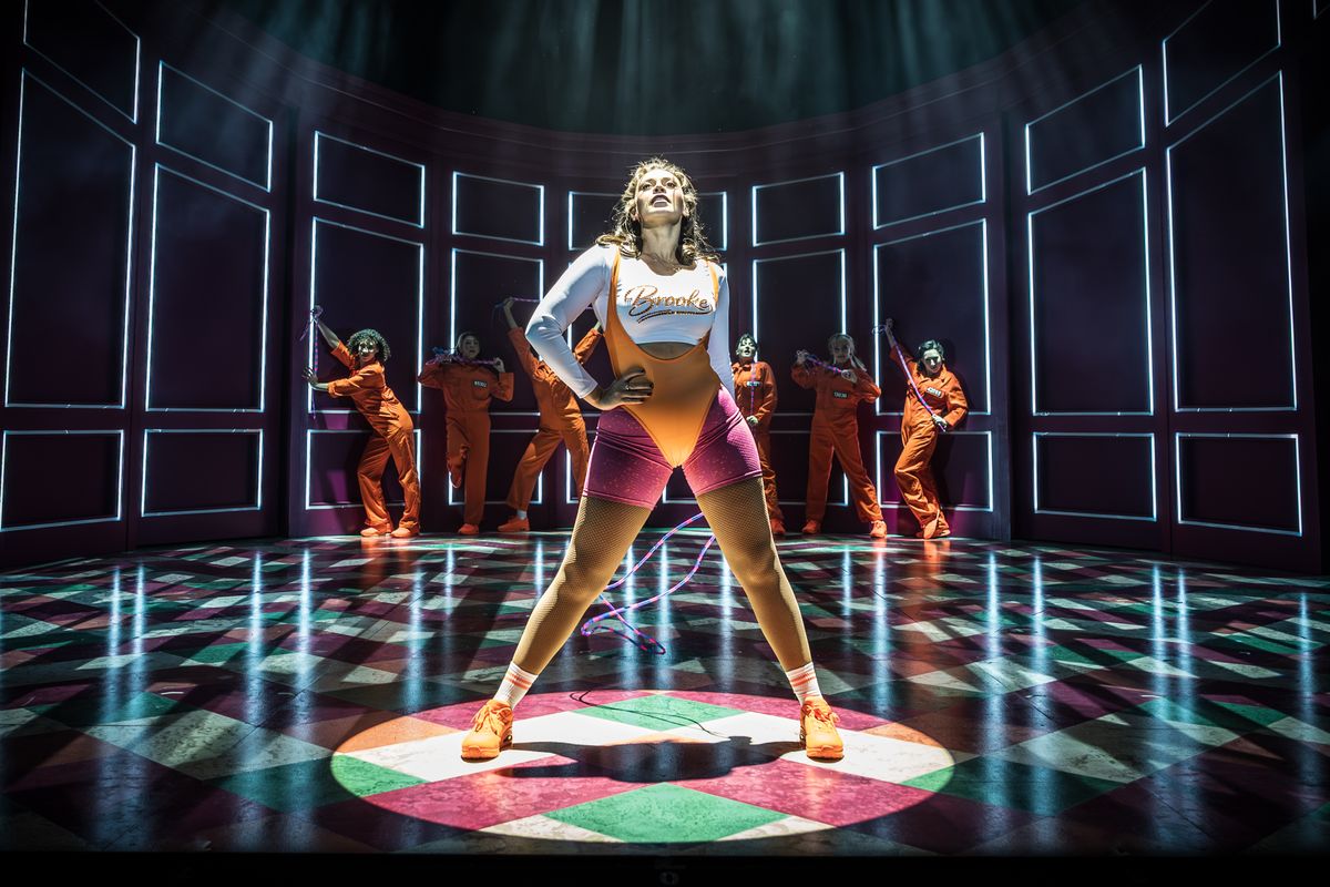 People stood on work out clothes with spot lights on them